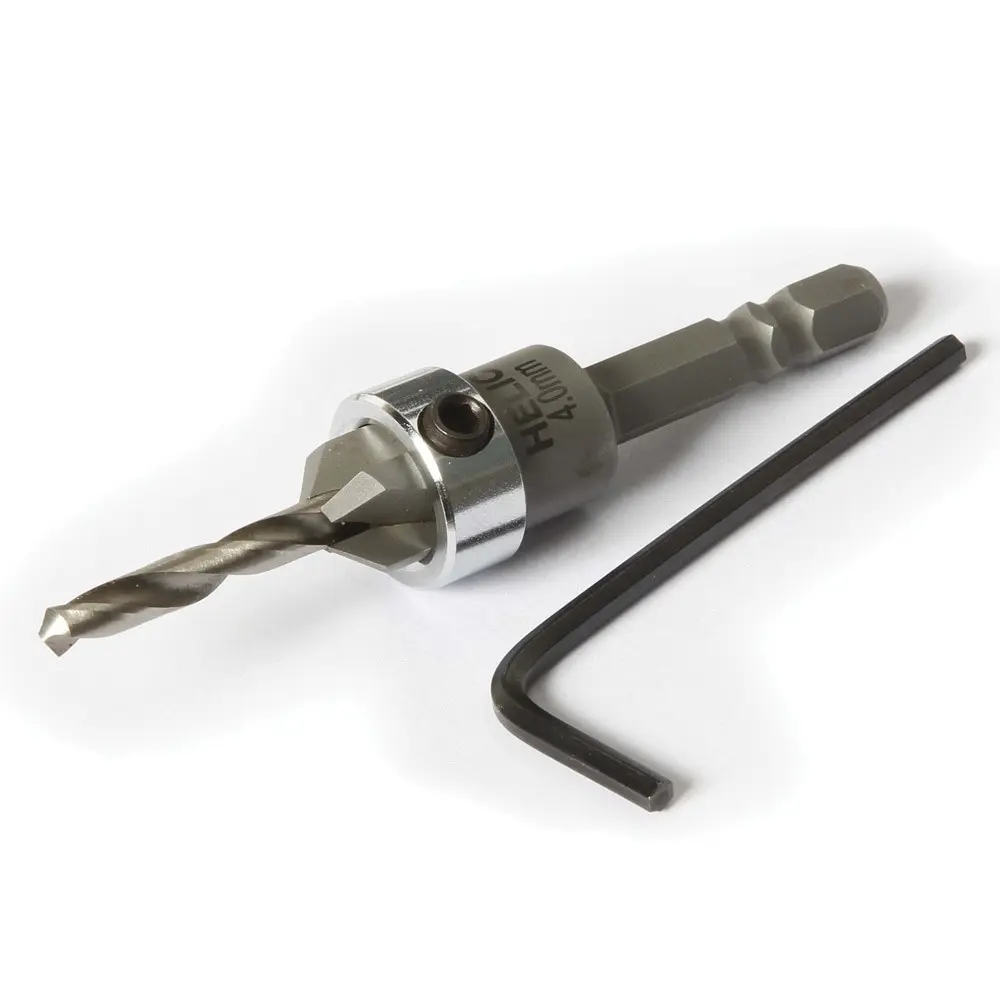 Foret fraisoir métal à queue hexagonale, clé hexagonale en L à côté. Aucun marquage visible. Fond uni blanc, produits sans emballage.